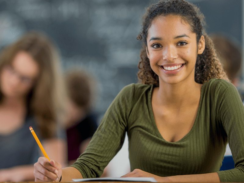 Female student smiling at the camera. Become a partner school with Oxford International's school immersion programme in the UK